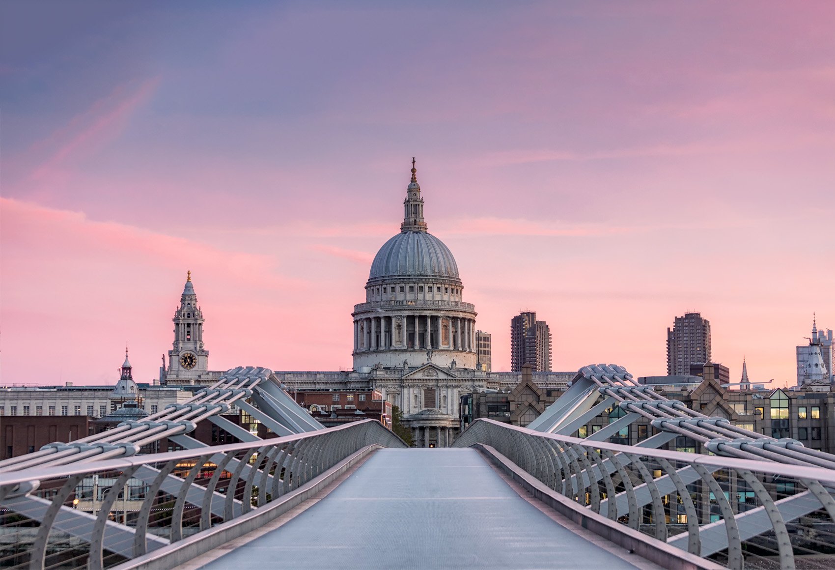 London's Millennium Bridge in the foreground with St Paul's Cathedral in the background at sunset