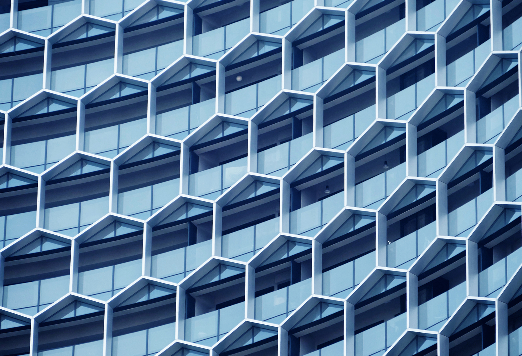 Facade of a modern office building featuring a hexagonal window structure.
