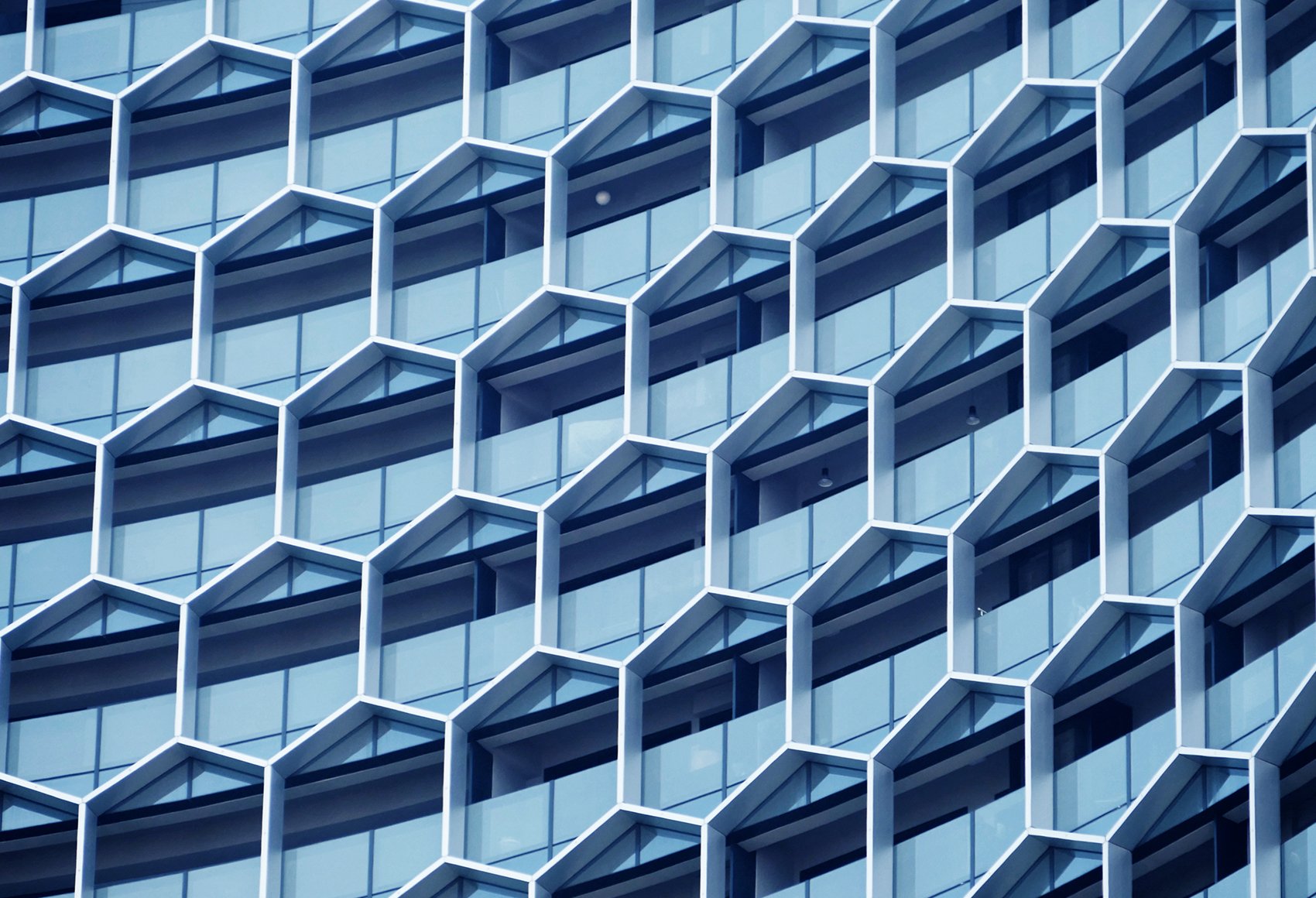 Facade of a modern office building featuring a hexagonal window structure.