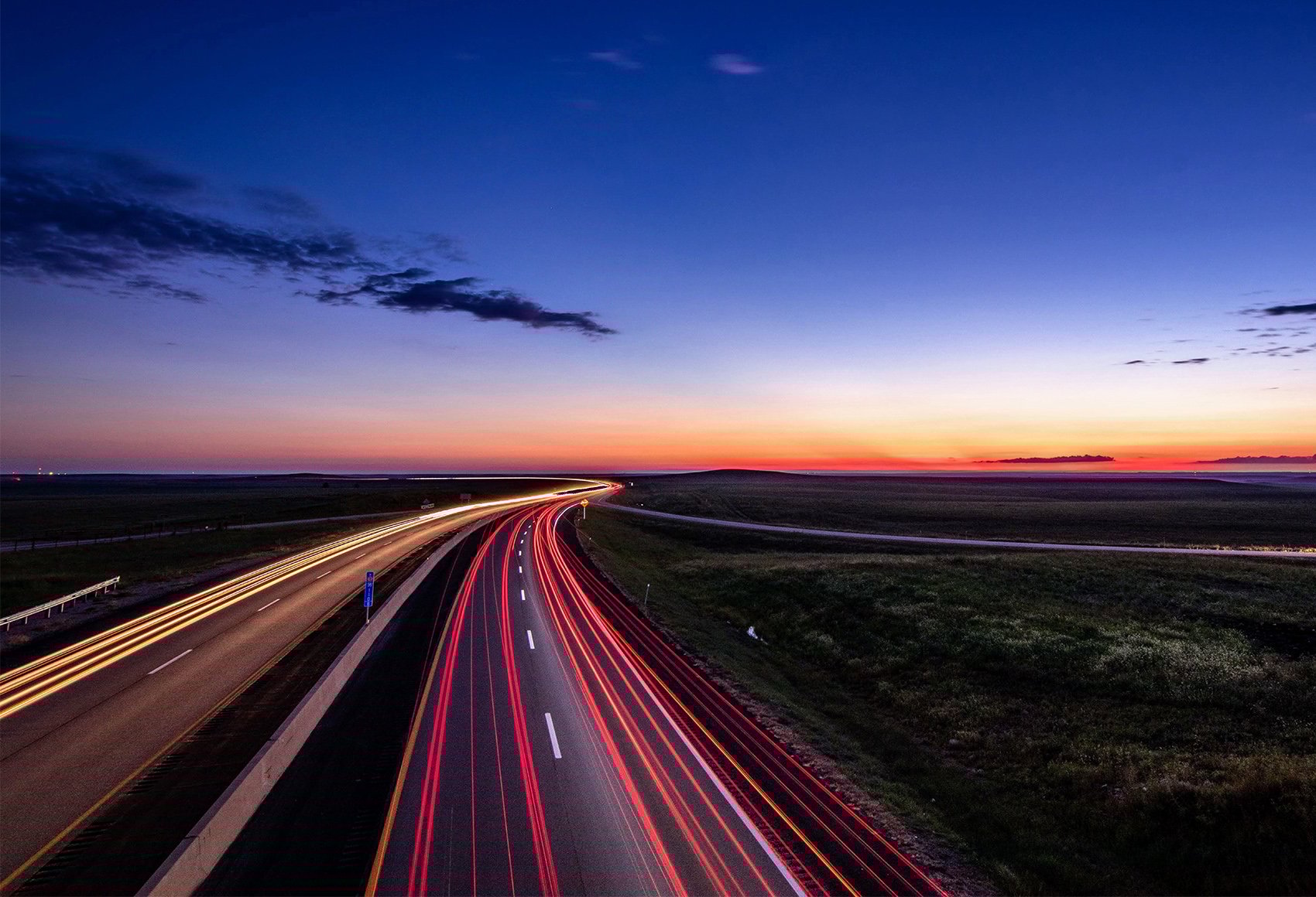 Late Stage Drug Development Commercialization Roadmap A night-time image of a long quiet road in the country side