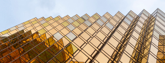 a close-up, angular view of a modern skyscraper's facade