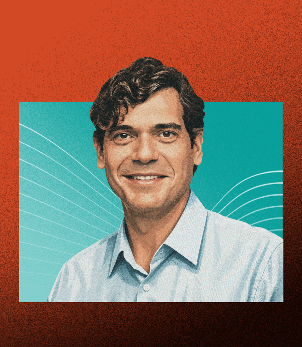 Smiling man in a light blue shirt against a teal background with curved white lines and a textured orange border.
