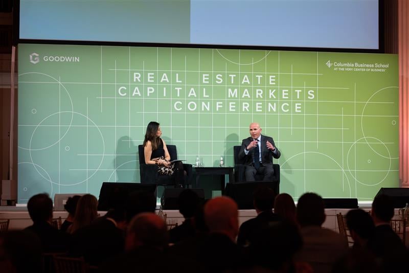 Conference panelists speaking during the Goodwin real estate capital markets event.