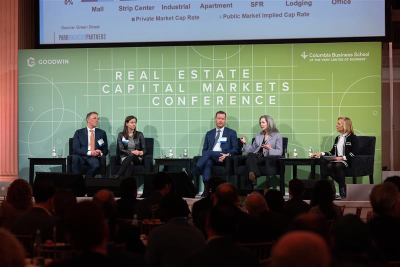Networking and discussion among professionals at the Goodwin real estate conference.
