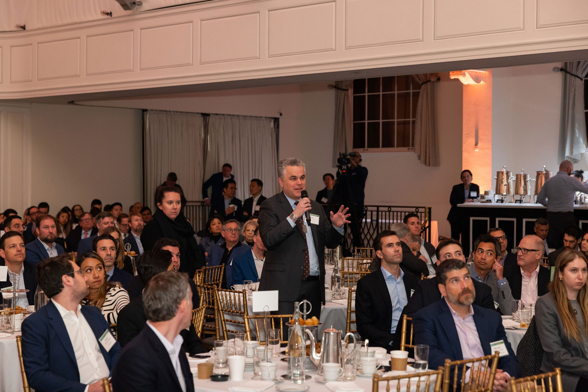 Presentation in progress at the Goodwin and Columbia Business School Real Estate Capital Markets Conference, featuring economic insights and data visuals.