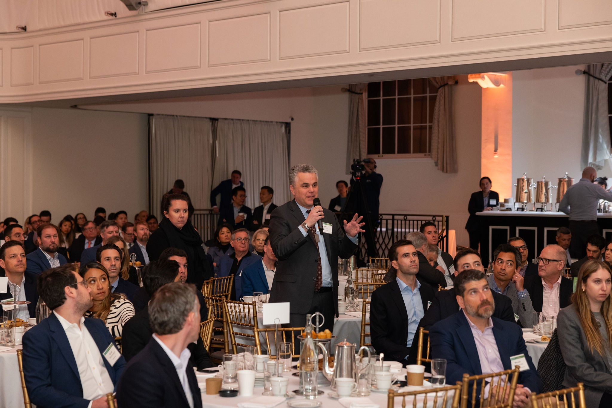 Presentation in progress at the Goodwin and Columbia Business School Real Estate Capital Markets Conference, featuring economic insights and data visuals.