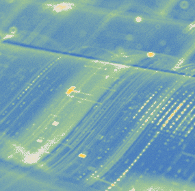 Abstract aerial-style view of roads or data pathways with glowing lines and dots in blue and green tones.