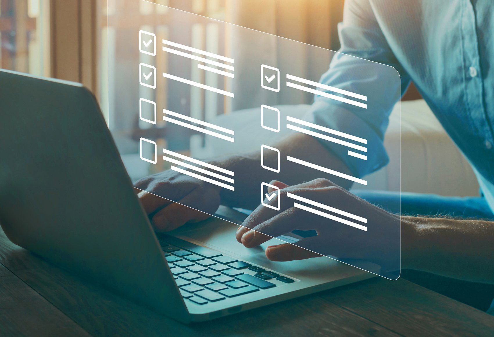 A person's hand resting on a laptop with an augmented display showing in front of them