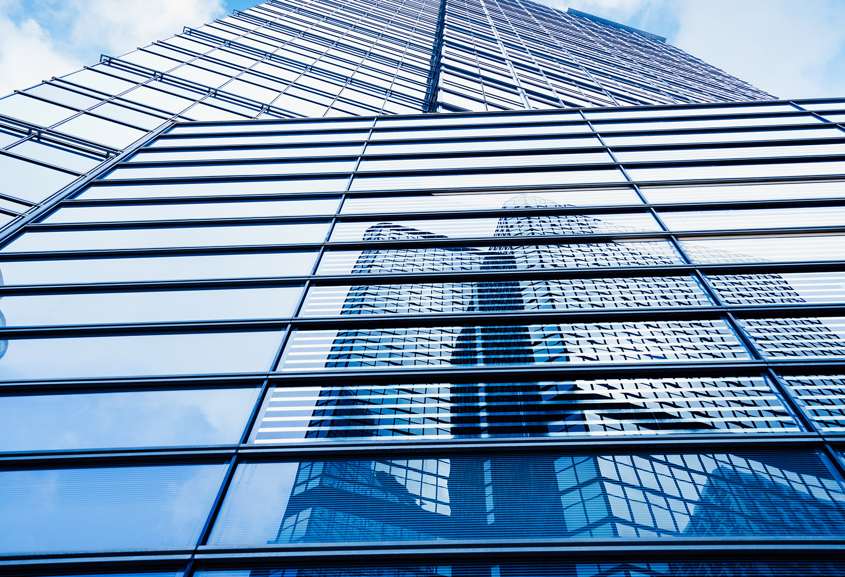Worms eye view of a tall glass skyscraper