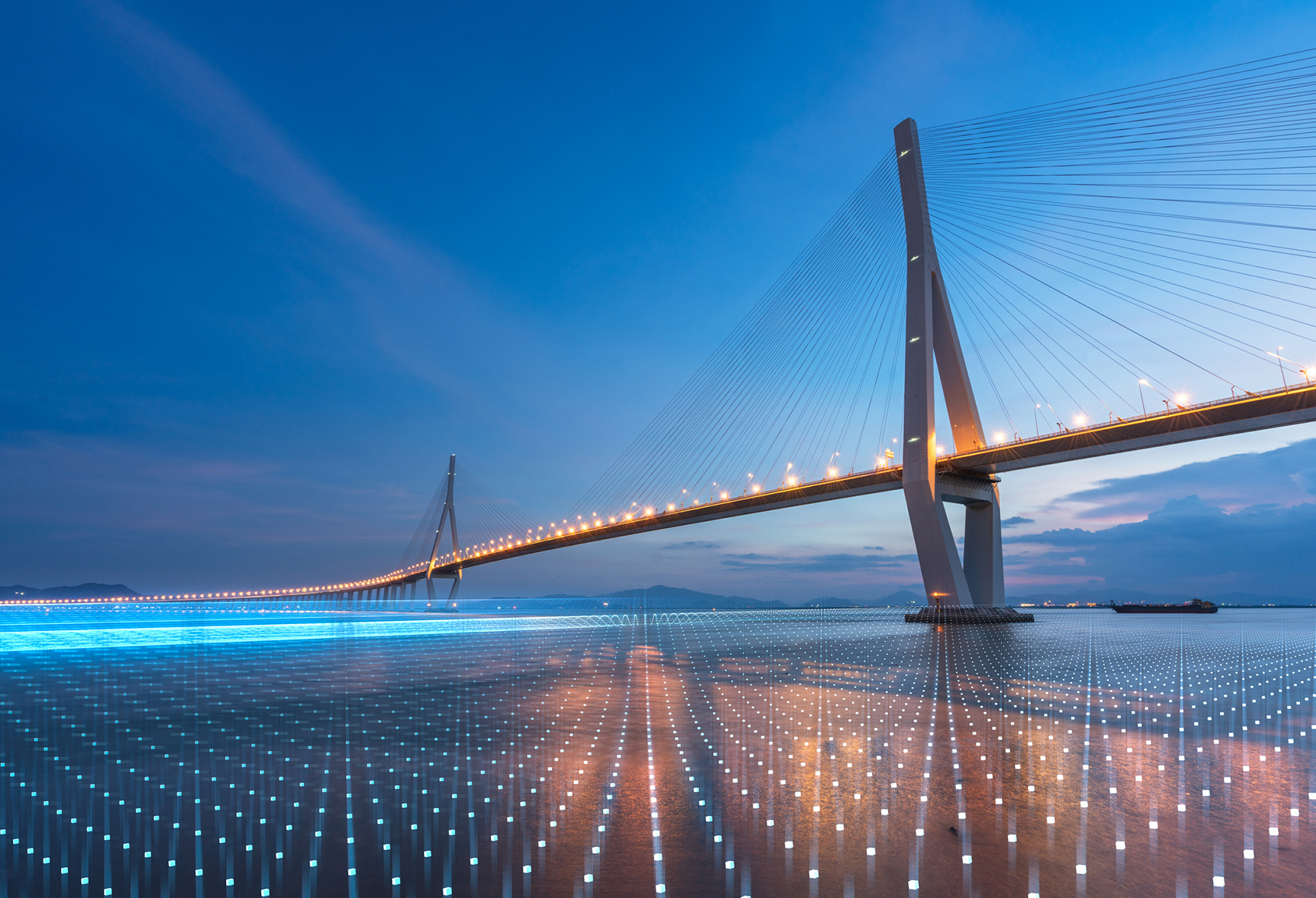 Well lit bridge over the ocean
