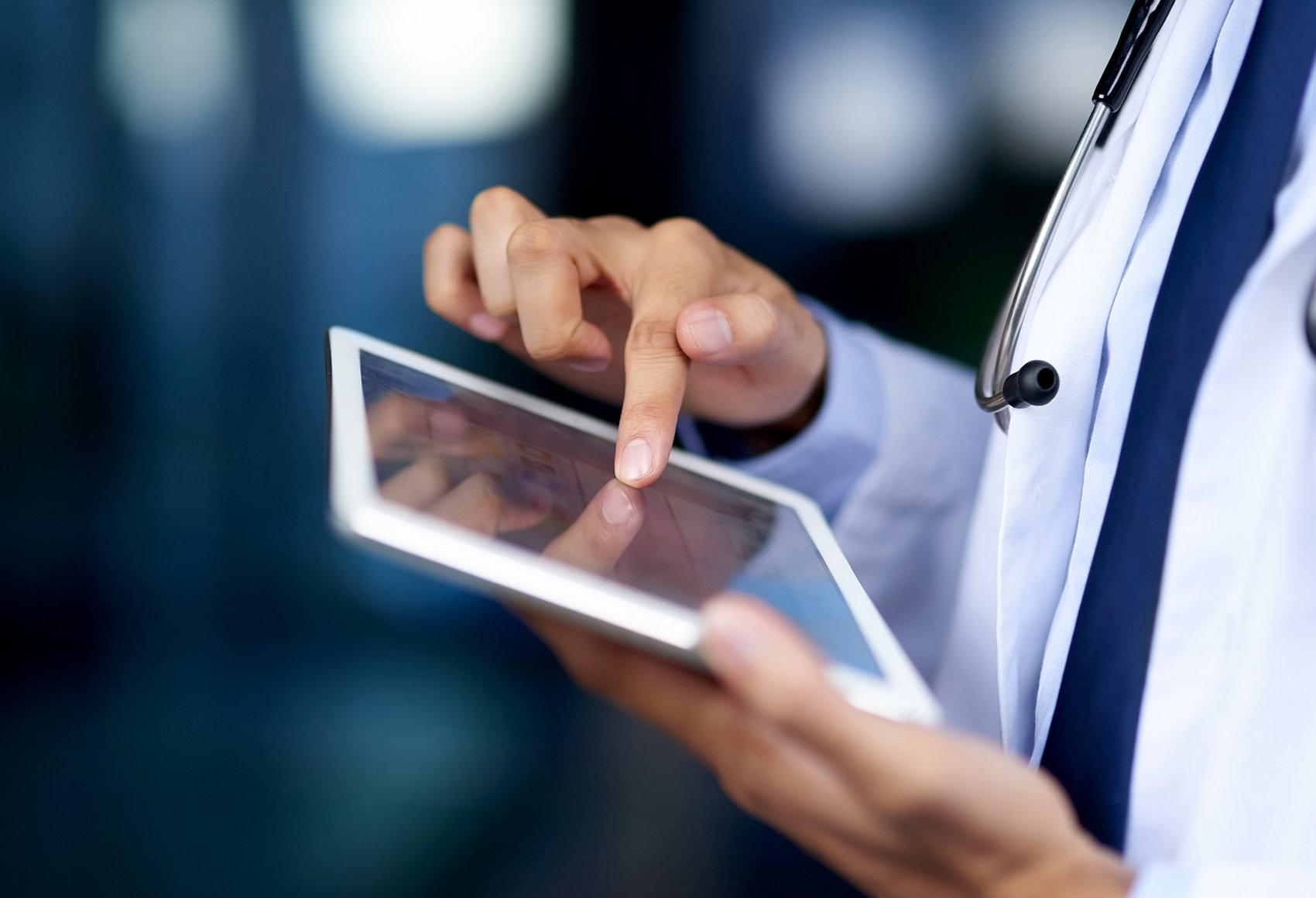 A healthcare professional using an electronic tablet