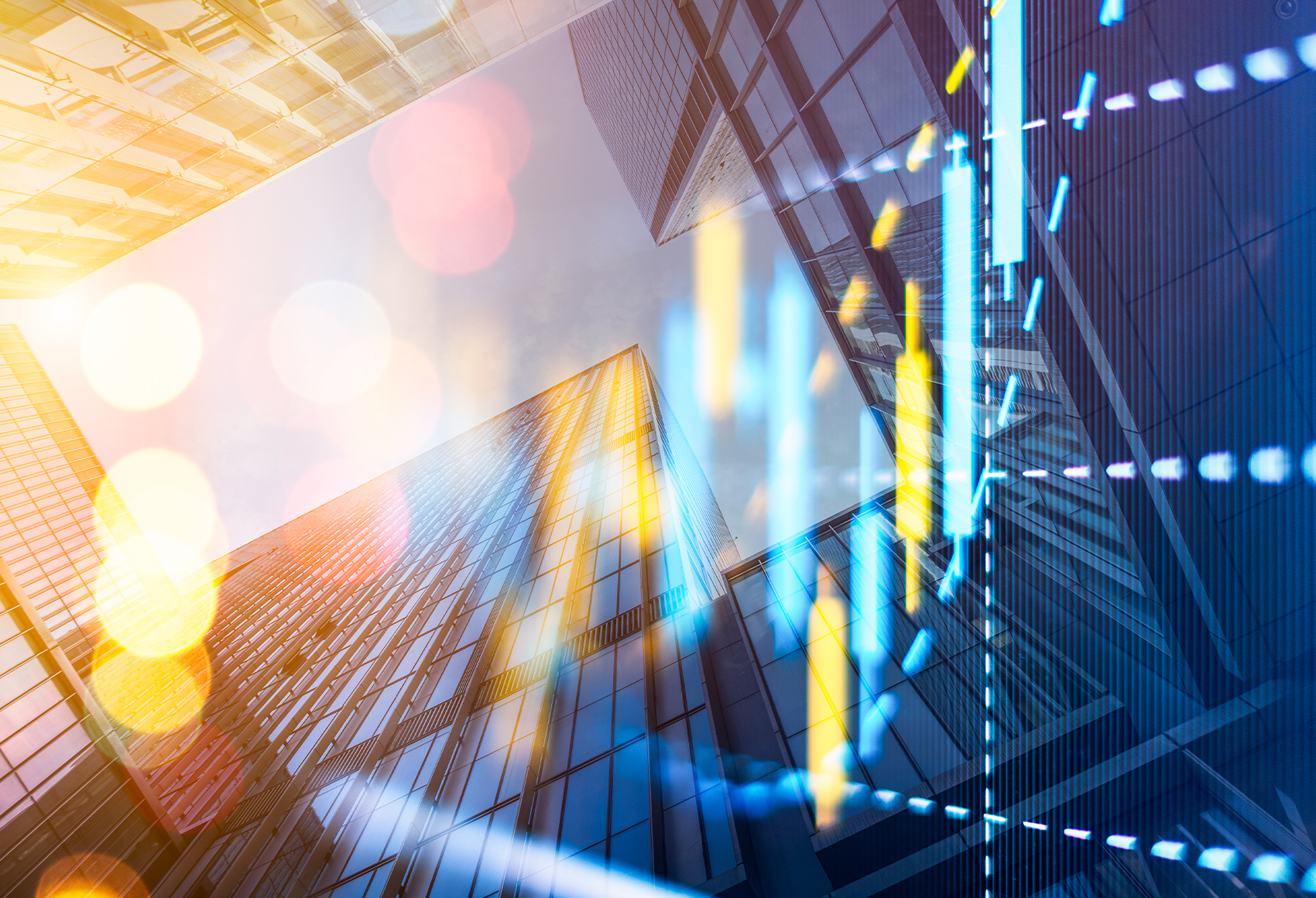 Upward view of modern glass skyscrapers with warm sunlight and lens-flare bokeh effects overlaid with translucent financial chart graphics in blue and yellow.