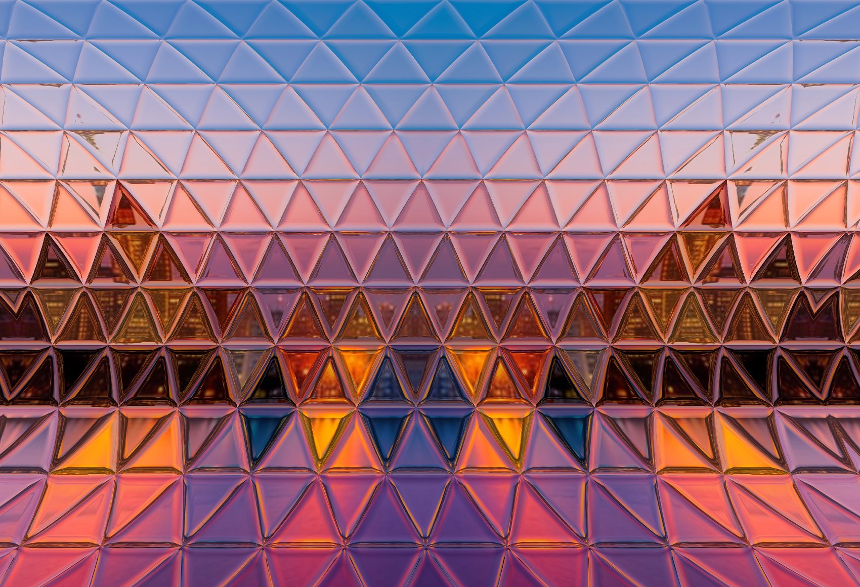 Abstract, geometric pattern composed of numerous triangles in varying shades of purple, orange, and blue